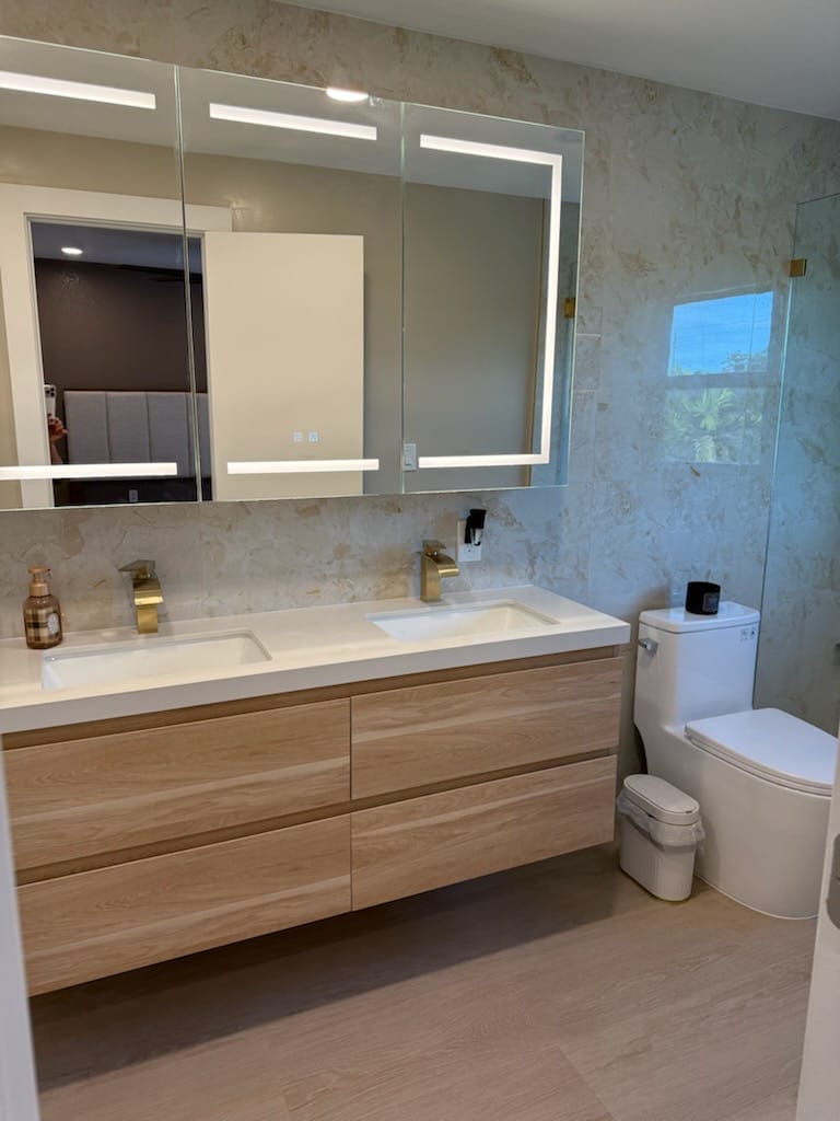 Baño con mueble flotante y espejo iluminado