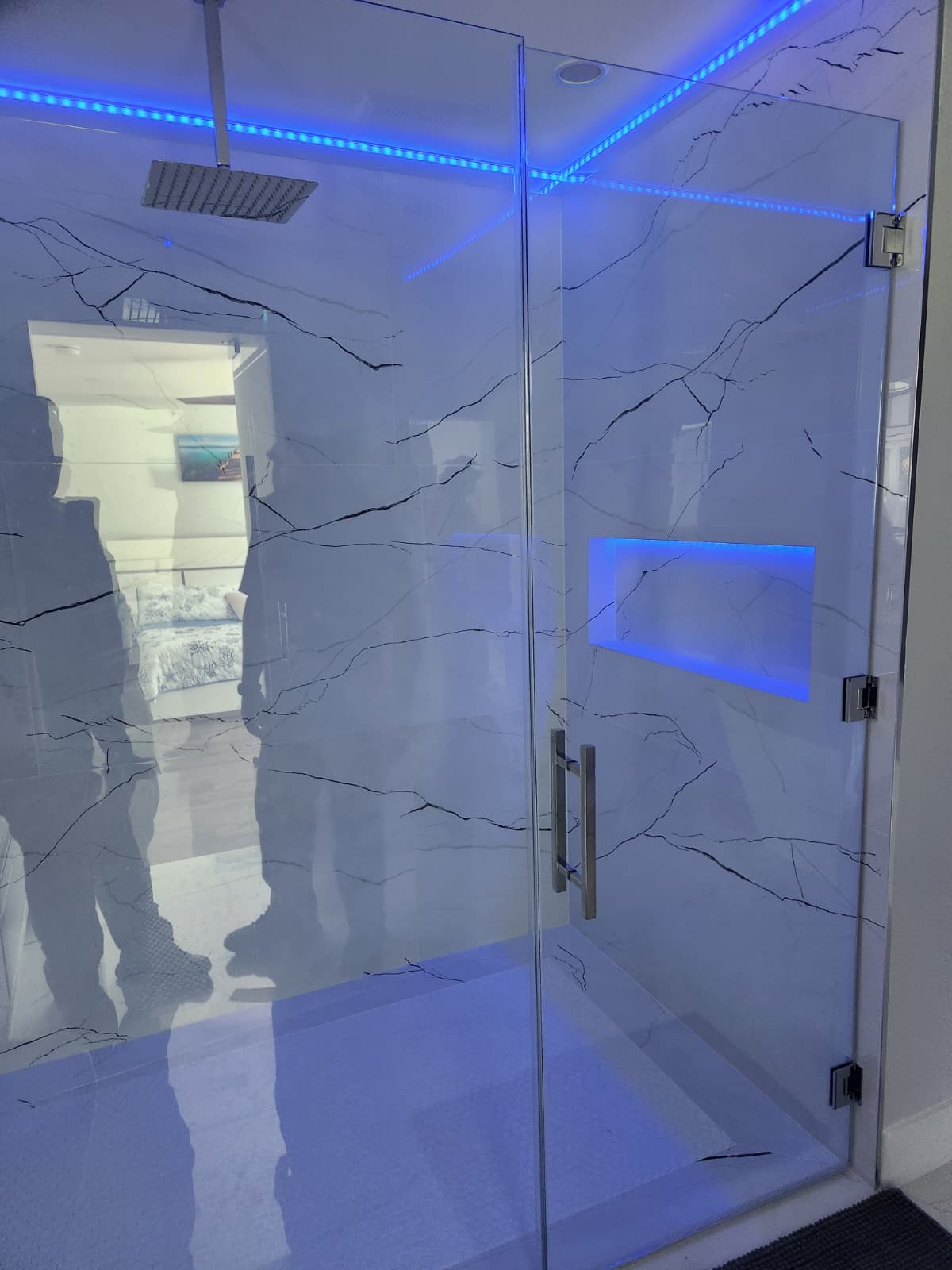 Ducha en mármol con puerta de vidrio e iluminación LED
